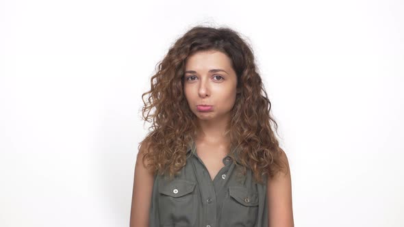 Charming Gentle Girl Pretending to Be Offended Smiling Feeling Happy Clapping Afterwards Isolated on alt