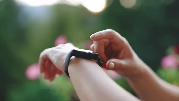 Closeup of Woman Using Smartwatch Touchscreen Wearable Technology Device