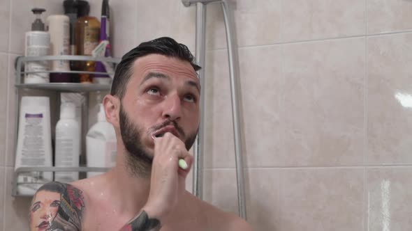 Close Up of Bearded Caucasian Man Brushing Teeth and Taking Shower alt