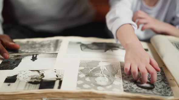Girl Scratches Photo of Baby Grandfather with Father at Home alt
