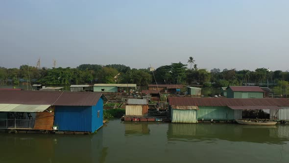 Floating fish farming community in Bien Hoa on the Dong Nai river, Vietnam on a sunny day. Drone tra alt
