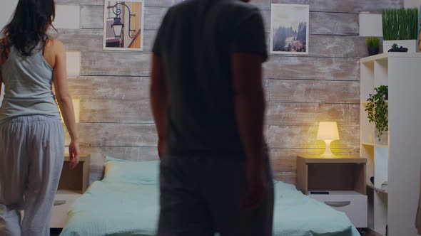 Cheerful Young Couple in Pajamas alt