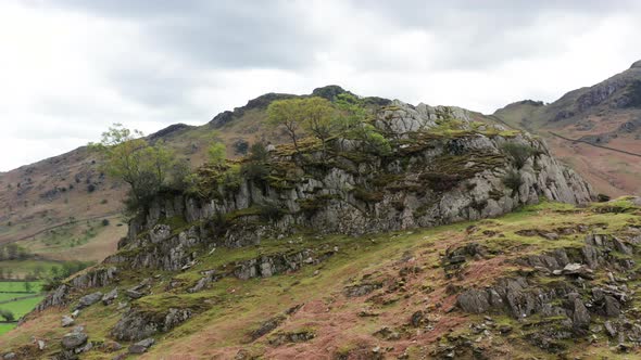 Aerial View Over Hills Towards Mountains