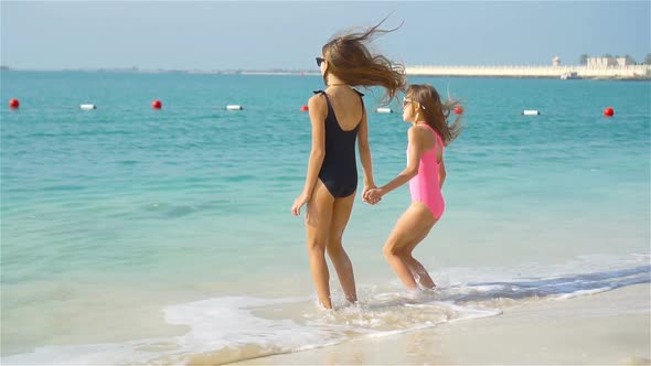 Little Girls Having Fun Enjoying Vacation on Tropical Beach alt