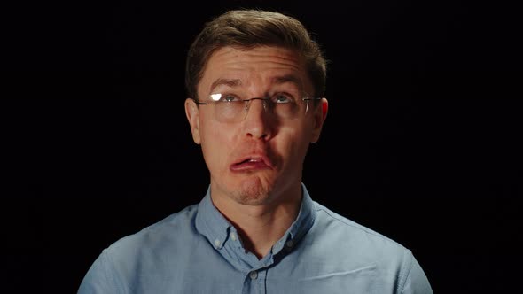 Young Man In Glasses Miming Are Changing Facial Expressions Quickly