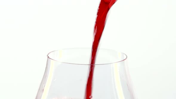 Red Wine Pouring Into a Glass, White, Closeup alt