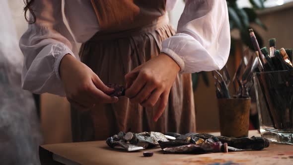 Art Studio  Young Woman Artist Working with the Oil Paints alt