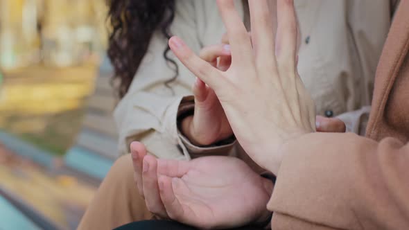 Romantic Date in Autumn Park Young Couple Sitting on Bench Touching Fingers Closeup Lovers Hold alt