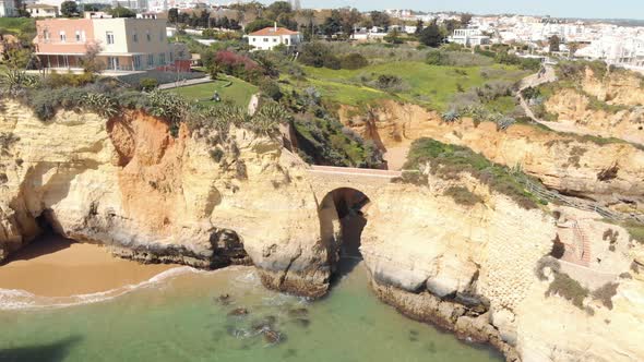 Roman style bridge connecting rock outcrops of Lagos Shoreline, Algarve, Portugal alt