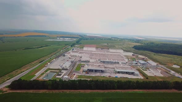 territory of the woodworking plant from above on the background of the countryside. Aerial view alt