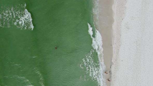 Tourist Playing in Ocean Waves on Tropical Beach - Overhead Aerial Drone View alt