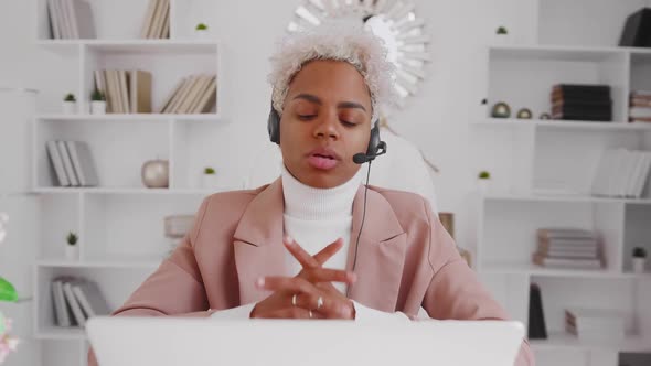 Smiling Latin Woman Office Worker Wearing Headset Conference Calling on Laptop alt