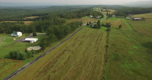 Aerial views of family bicycling along pastoral country roads. alt