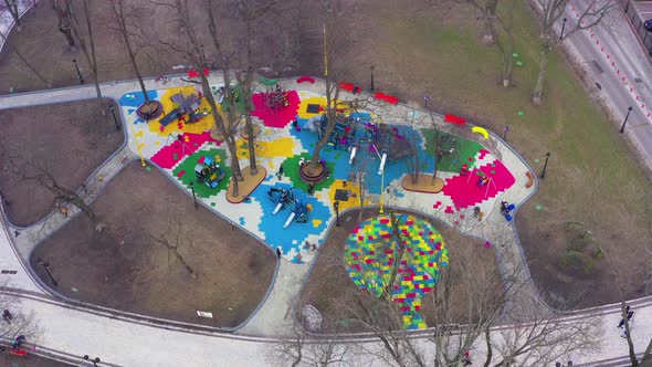 Children's Colourful Outside Playground with Carousels Swings and Slides alt