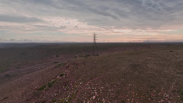 Drone Orbiting Around Electric Pylon During Dusk
