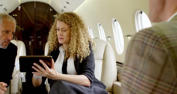 Business People Discussing Over Digital Tablet  alt