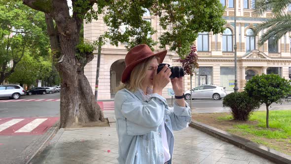 Photographer Takes a Pictures on Camera in the City