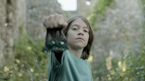 Proud Boy Stretching Hand with Package of Stones Forward alt