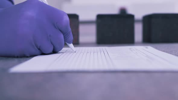 A Scientist Makes Notes on Paper