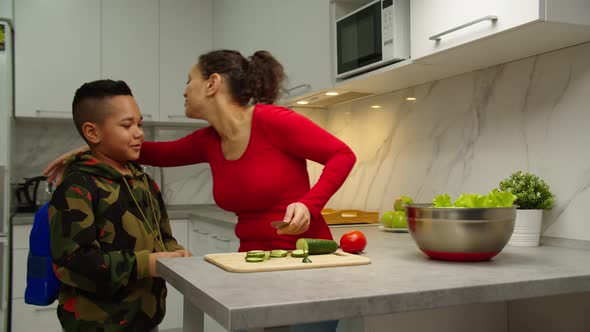 Loving Parent Greeting Preteen Son Cuddling Child Indoors alt