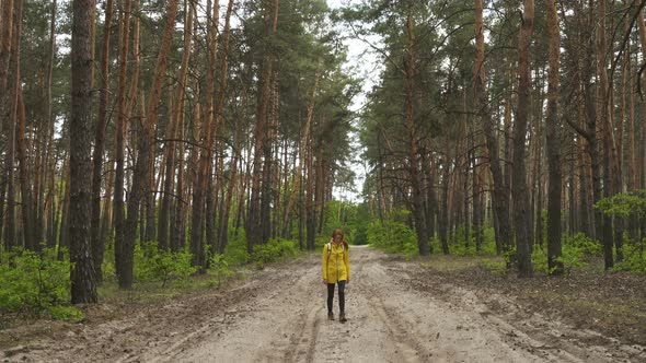 Girl Walking By The Forest Road