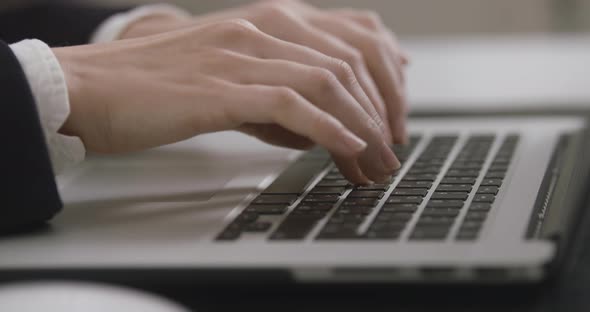 Close Up Shot of an Young Business Woman's Hands Working on Laptop