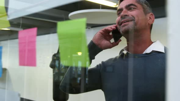 Businessman talking on mobile phone in modern office 4k