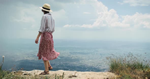 Woman Traveler on Mountain Top Lookig at City From Height of Flying Flight alt