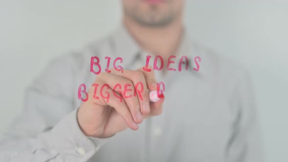 Big Ideas Bigger Results Writing on Screen with Hand alt