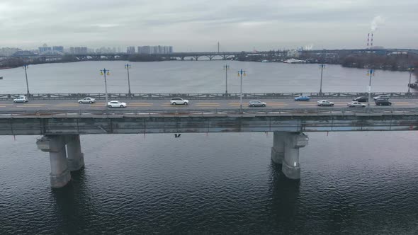 Traffic on a Bridge Over a Wide River in the Winter