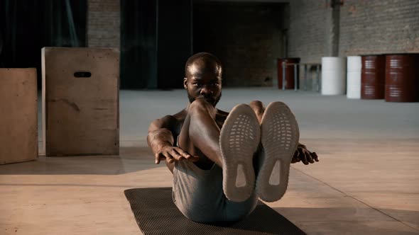 Sport man doing abs exercise workout at gym indoors. Fitness alt