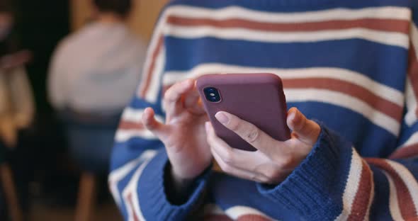Close up of woman use of mobile phone in coffee shop