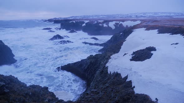 Rough Ocean Water Crashing against Rock Cliffs in Arnarstapi in Iceland
