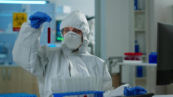 Neurologist with Ppe Suit Working at Vaccine Development Analysing Blood Sample alt