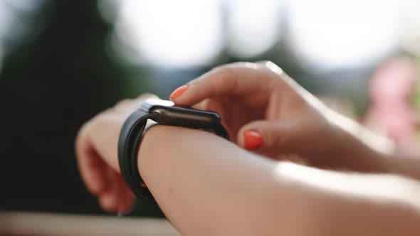 Woman Using Her Smart Watch Touchscreen Wearable Technology Device