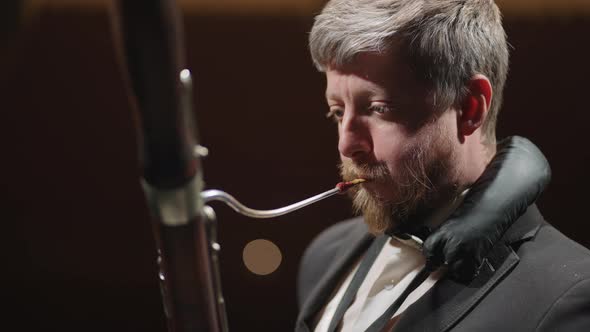 Classic Musician is Playing Bassoon in Rehearsal or Concert of Symphonic Orchestra Closeup alt