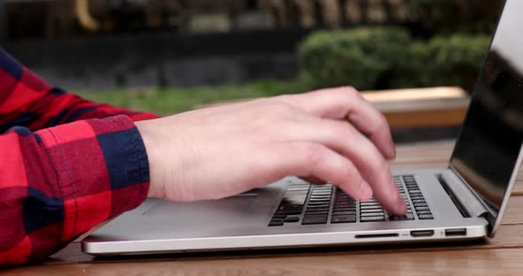 Close up of man hand typing on laptop keyboard.