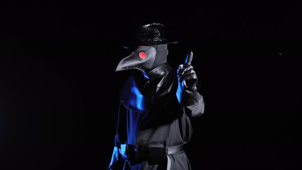 Plague Doctor with Crow-like Mask Disapproving with No Finger Sign, Make Negation Gesture, Denying alt