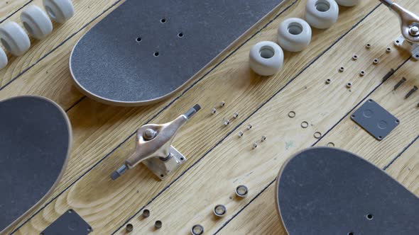Countless disassembled skateboard parts laying on a wooden floor exposition 4KHD alt