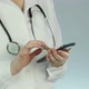 Female medical employee viewing lab results using smartphone, technical progress - VideoHive Item for Sale