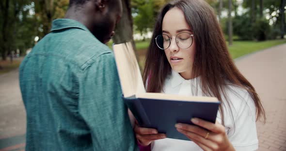 Student Girl with Book Hit in Park