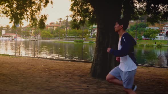 Young Asian man working out in a park in Los Angeles. alt
