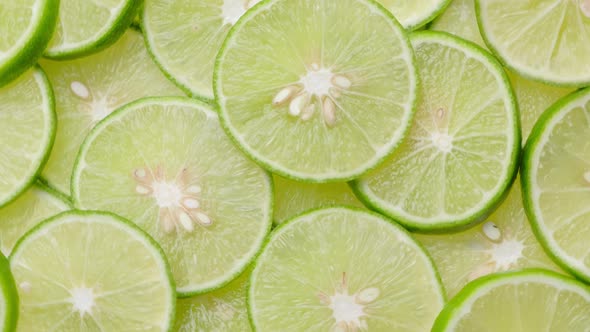 Top view limes slices rotation, close up.