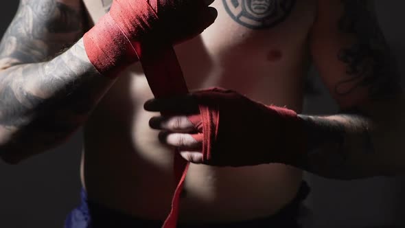 Close Up Boxer Pulling Red Bandages on Hands, Muay Thai Combat Sport, Slow-Mo alt