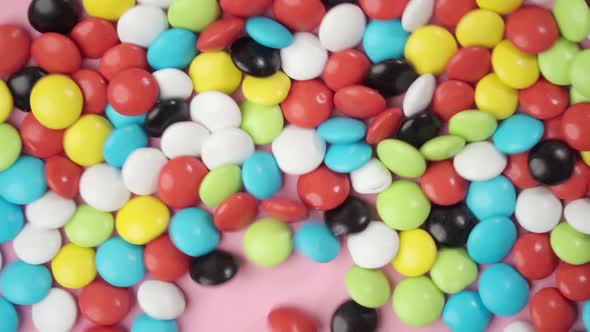 Colorful Candy Dragees Jump on the Surface