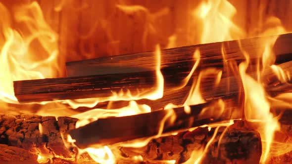 There's Firewood Burning in the Fireplace. Beautiful Flame in Modern Fireplace alt