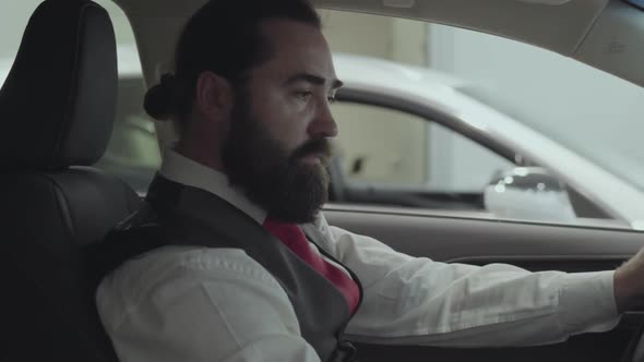 Portrait Attractive Successful Bearded Businessman Sitting in the Vehicle and Inspects Newly alt