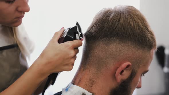 Barber Clippering Client's Hair with Machine in Barbershop, Stock Footage