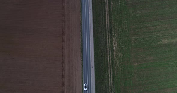 Aerial Drone Content  Road with Light Traffic on Outside City and Arable Lands