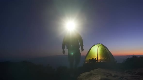 an Adult Man in an Adventure Trip To the Top of a Mountain Set Up a Tourist Tent for an Overnight alt